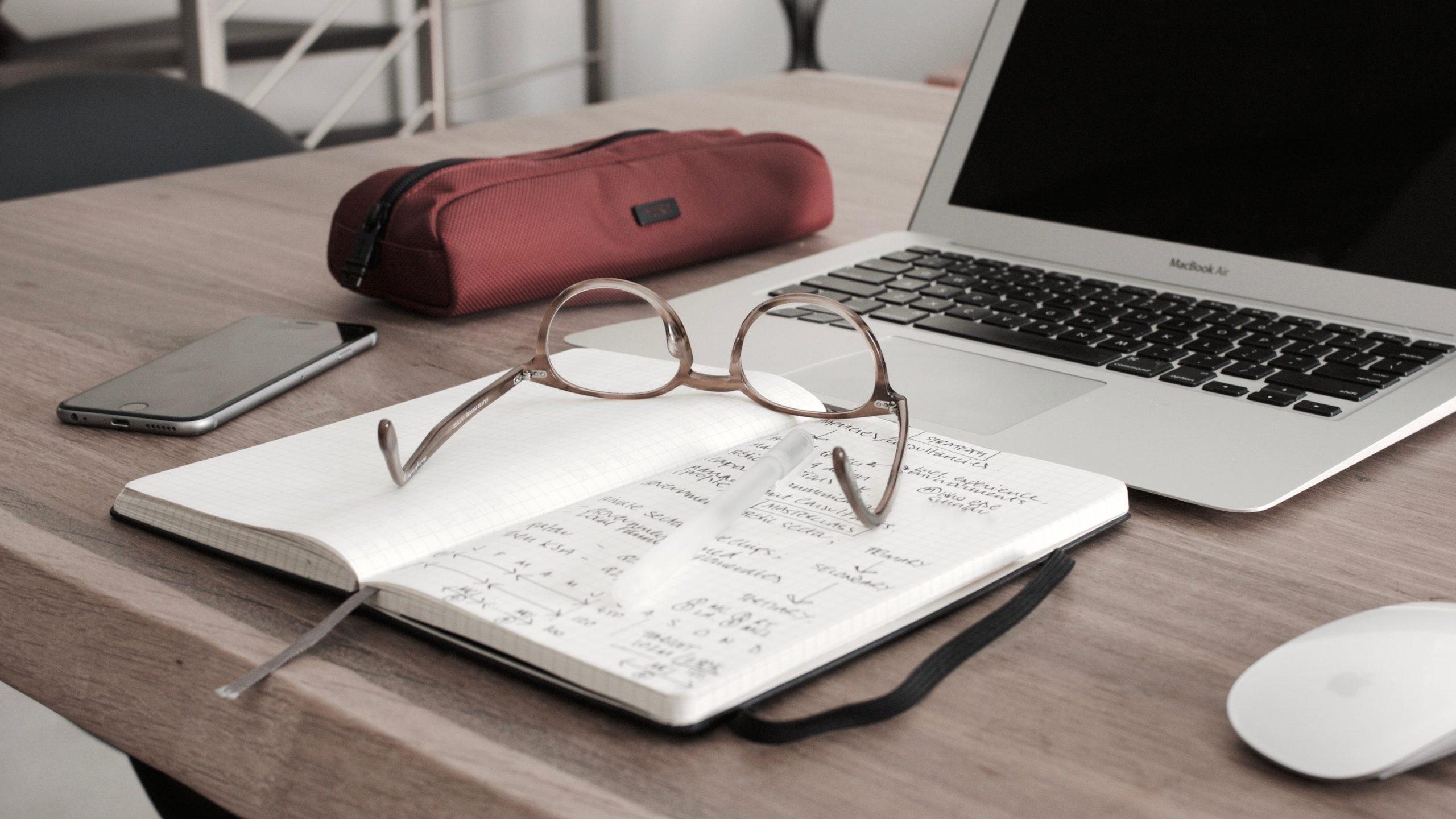 Notepad and computer on a desk | Small Business Bookkeeping | Neat